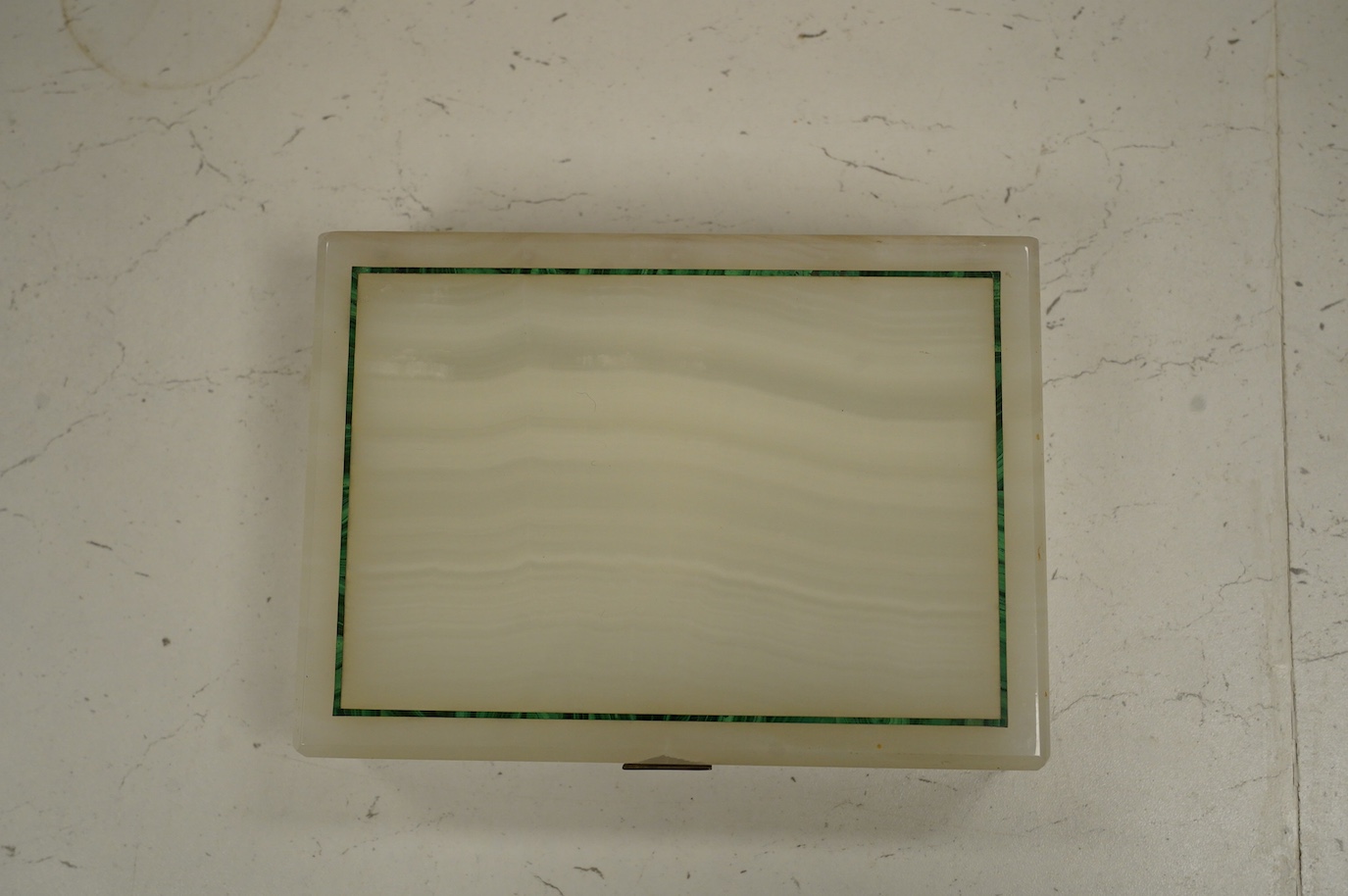 An Art Deco white onyx and malachite-banded box, with silver-gilt hinge hallmarked for London 1938, 19 x 14 x 5cm. Condition - poor to fair